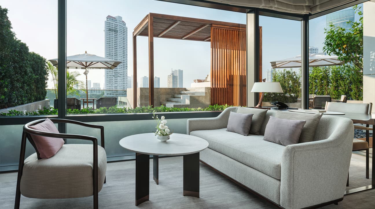 Modern outdoor seating area with a cityscape view in Capella Bangkok