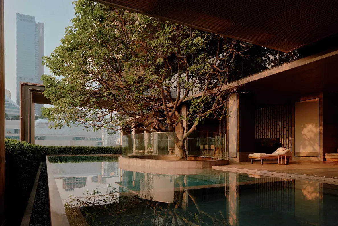 Aman Nai Lert Bangkok pool with tree, Thai design, luxury urban sanctuary hotel